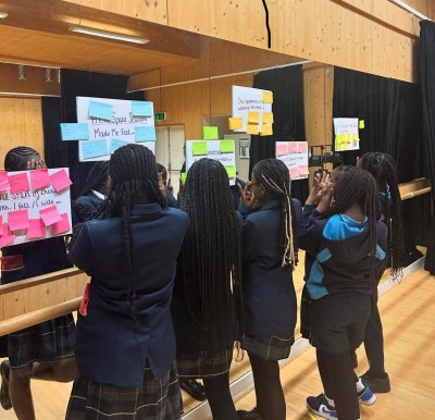 Girls reading information at a Milk Honey Bees event