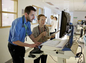 Clinicians looking at computer together overview